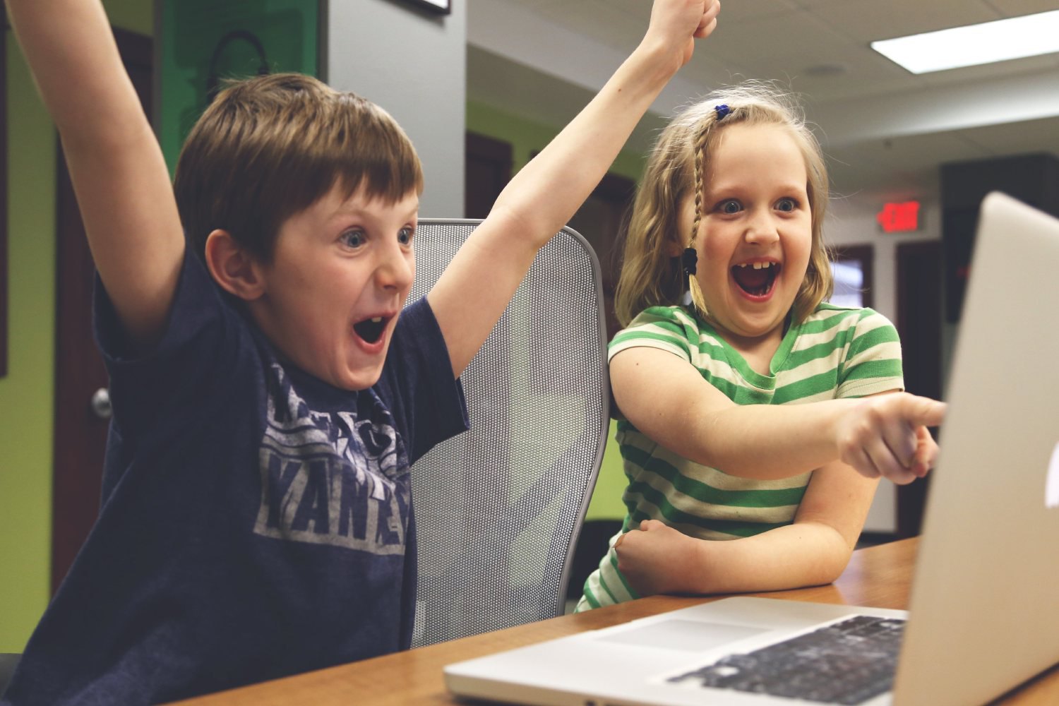 Excited children with computer